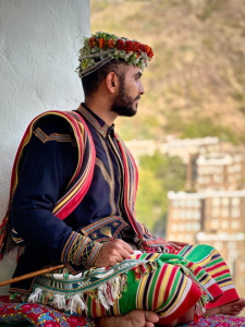 Man seated in colourful clothing in Saudi Arabia